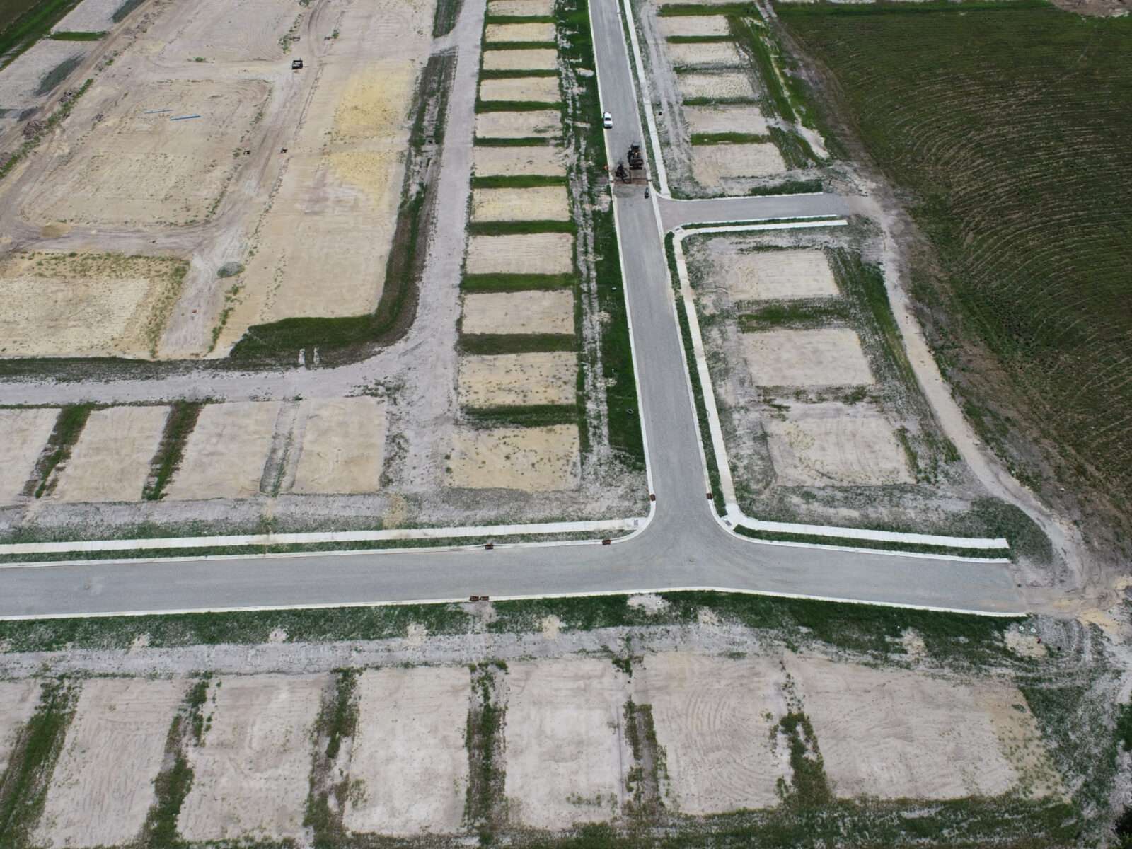 An aerial view of a subdivision street under construction.